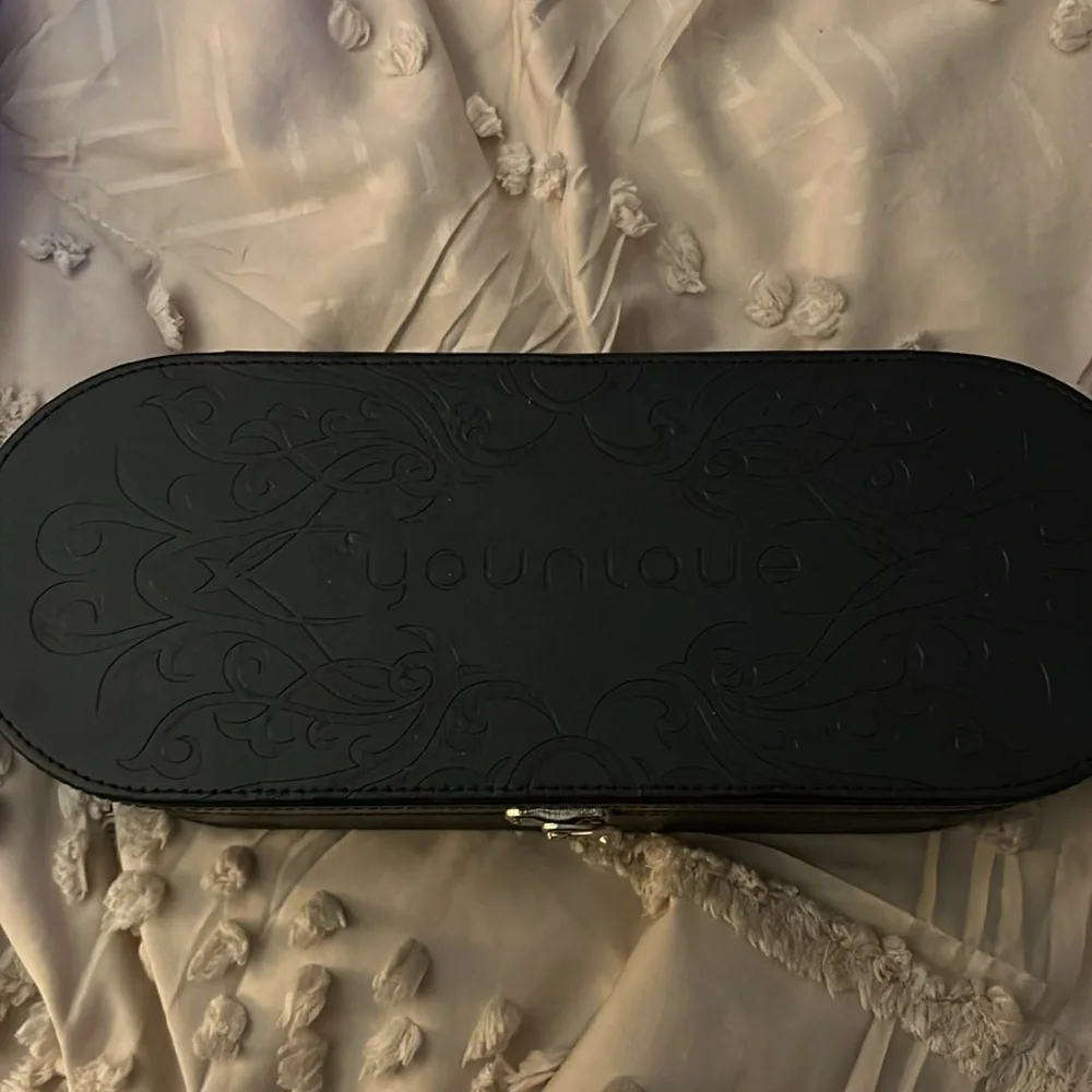 Younique black oval representative make up. Cosmetics case beautiful on vanity